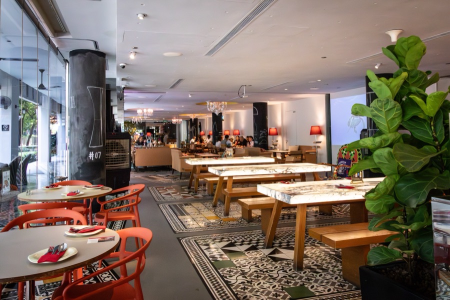 Inside Beast & Butterflies at M Social Robertson Quay, with its orange chairs and Peranakan-tile floors