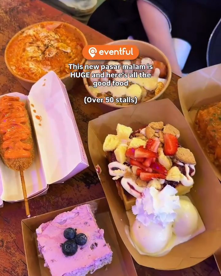 A table of CCK pasar malam food: a corn dog, a strawberry crumble dessert with ice cream, a blueberry cake and a bowl of noodles
