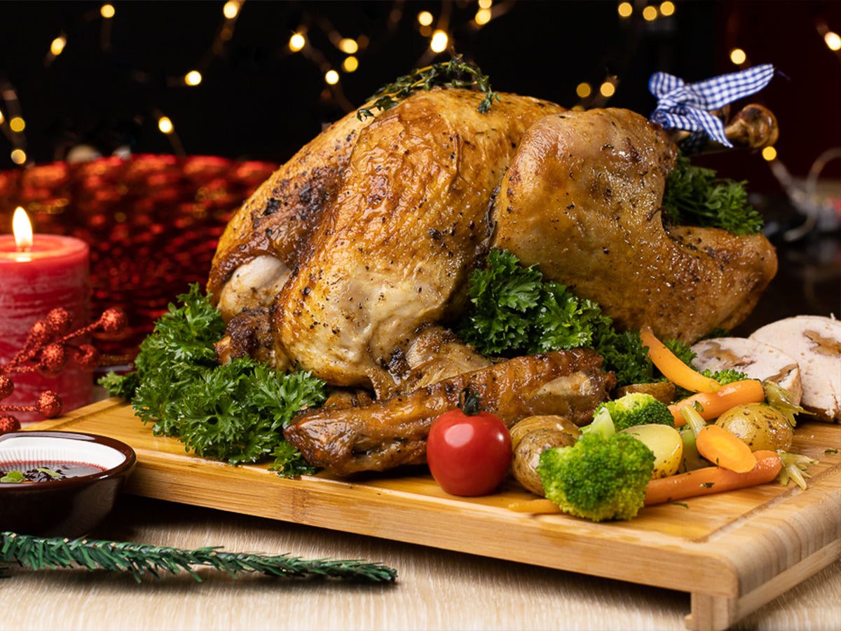 Traditional roasted turkey with stuffing on a carving board