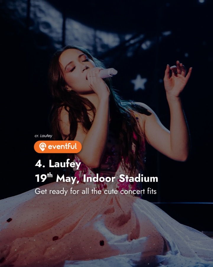Laufey singing on stage in a pink tulle dress