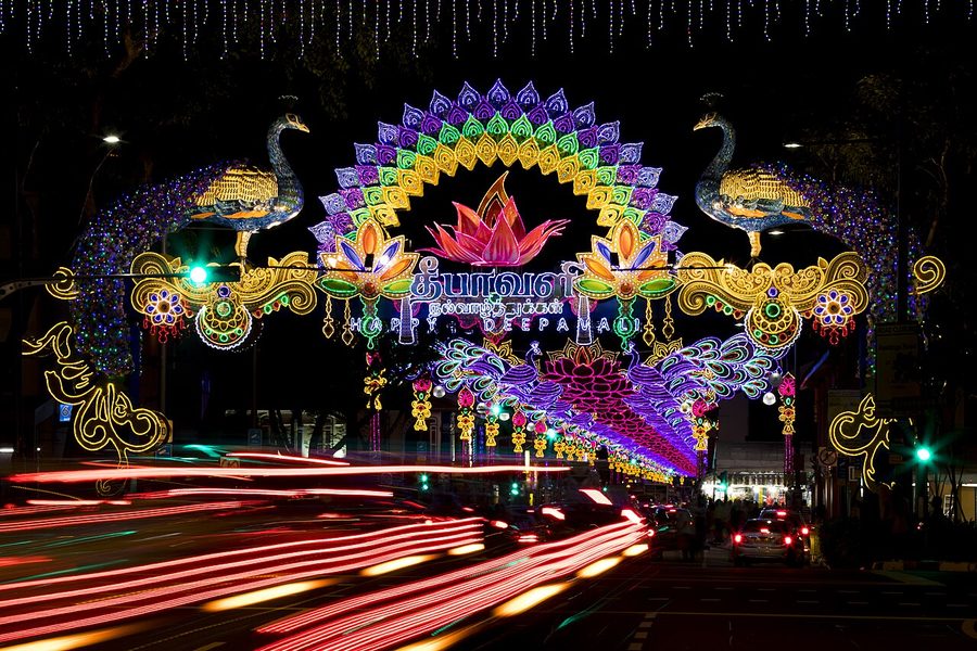 Deepavali arches lit up over Serangoon Road at night, with traffic below