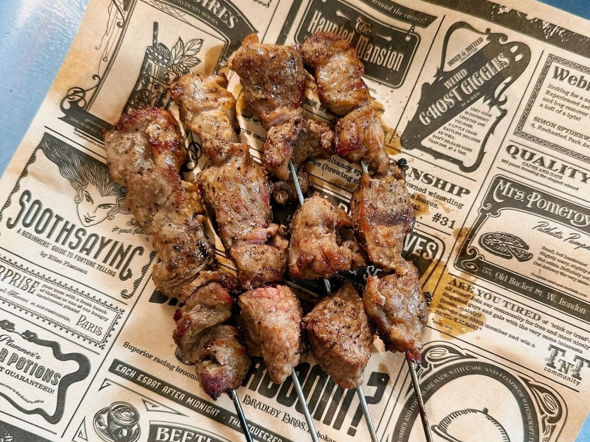 Lamb skewers on newspaper print at NOMADS Seletar