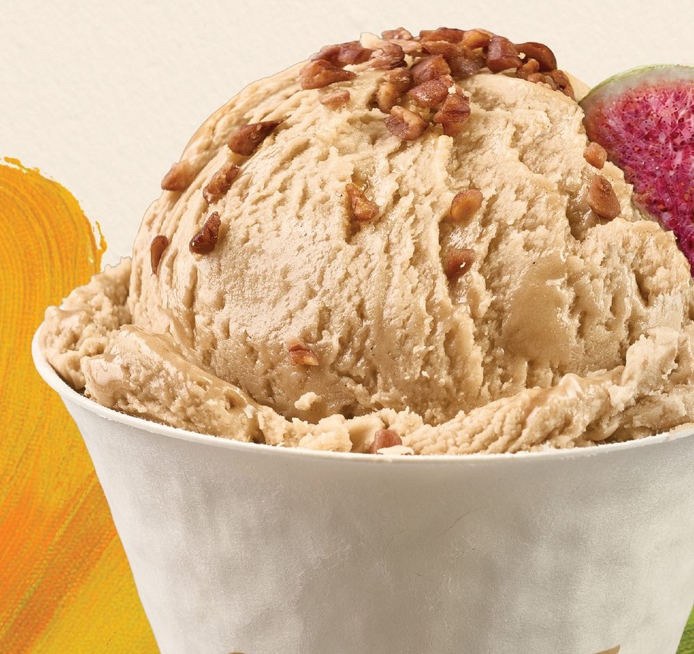 A scoop of CHAGEE Geelato topped with pecans in a CHAGEE cup