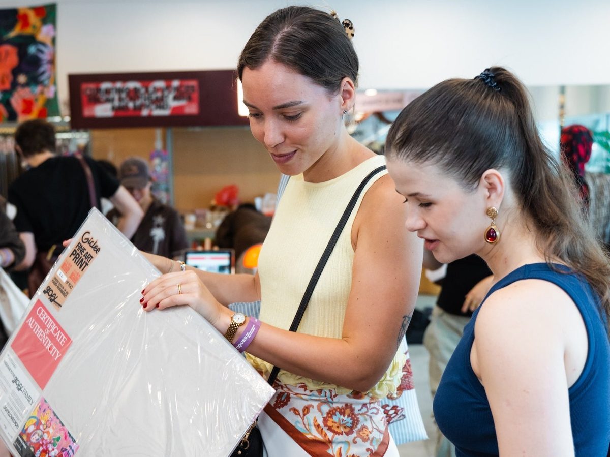 Shoppers browsing art prints at a Boutiques Singapore fair