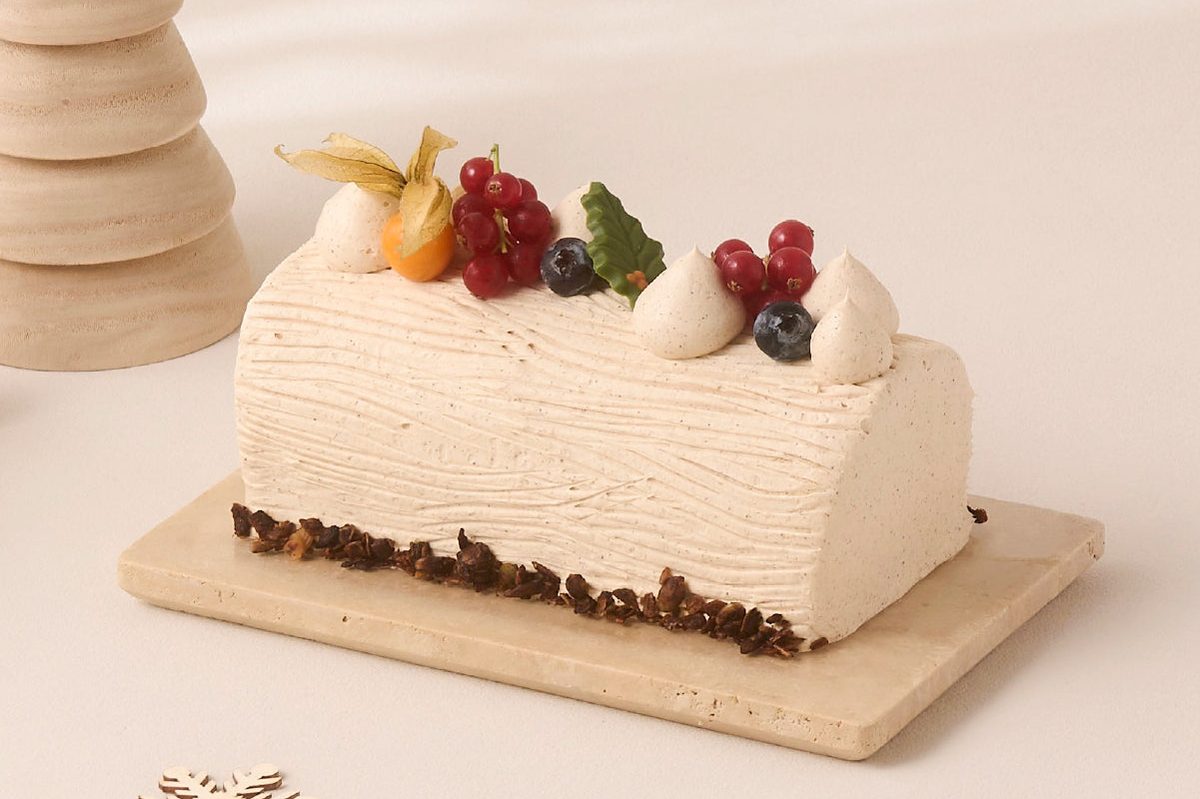Cedele Spiced Apple Noel Log Cake with cinnamon frosting and berries