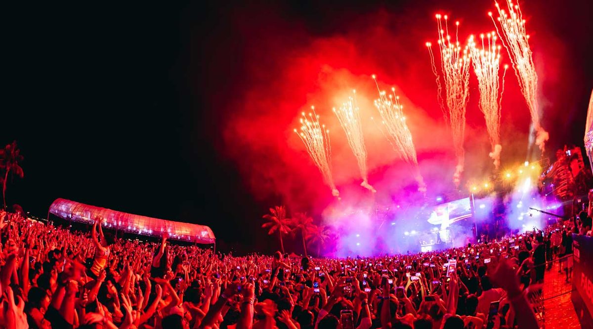 Fireworks over a packed Siloso Beach countdown crowd on Sentosa