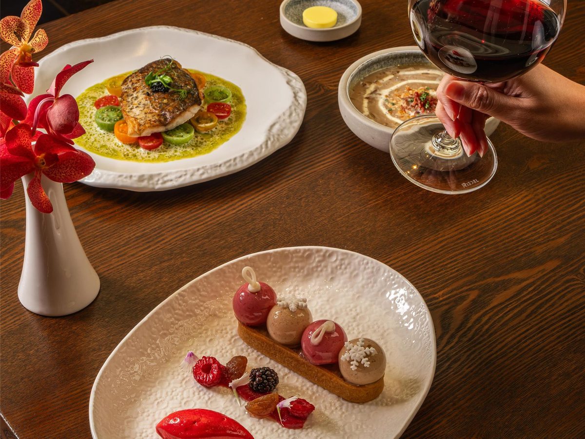 Plated festive dishes and red wine at The Capitol Kempinski Hotel Singapore