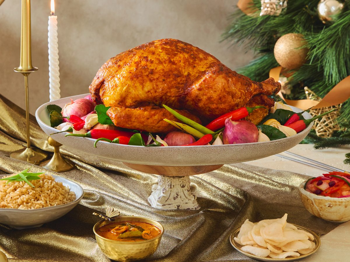The Fullerton Kam Heong roast turkey on a platter with rice and pickles