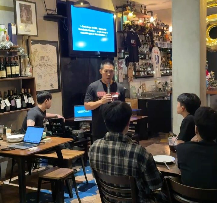 A speaker presenting in front of a screen at the Eventful event at WLJK