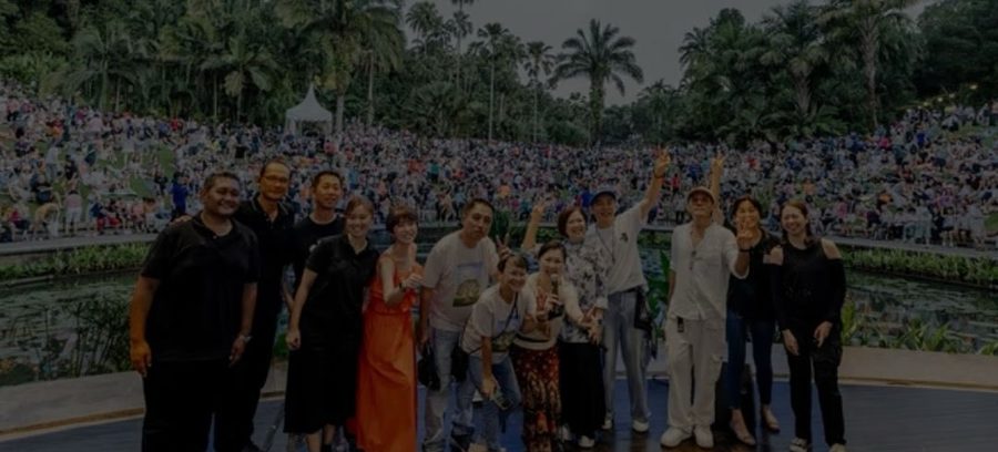 Crowd on the lawn at the Singapore Botanic Gardens during a concert