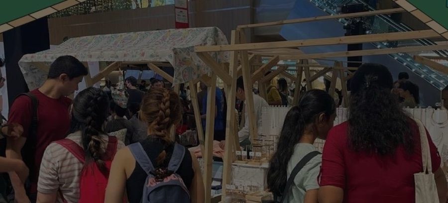 Shoppers at the AL!VE Artisans Market browsing stalls of handmade goods