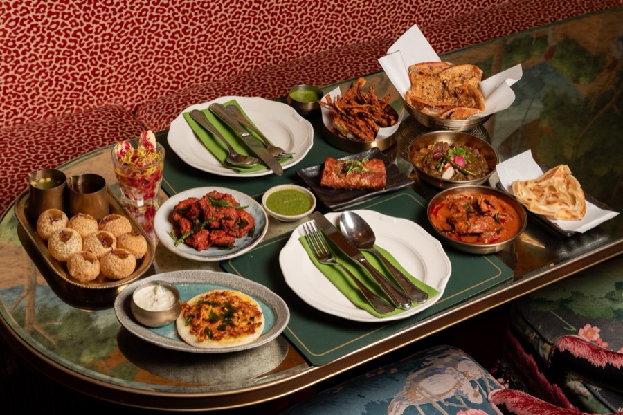 Pani poori, curries, tandoori and naan laid out on a table at Gupshup