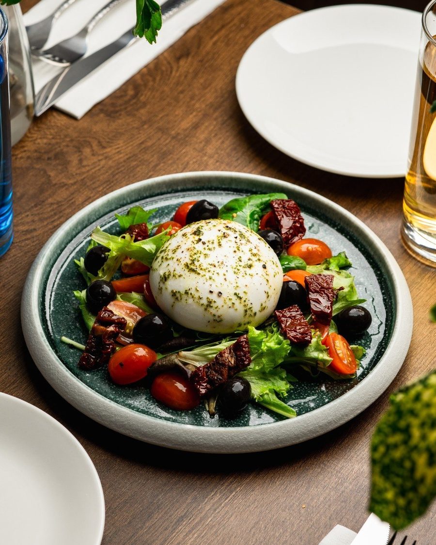 Burrata salad with tomatoes and greens at Epicurean Fusion
