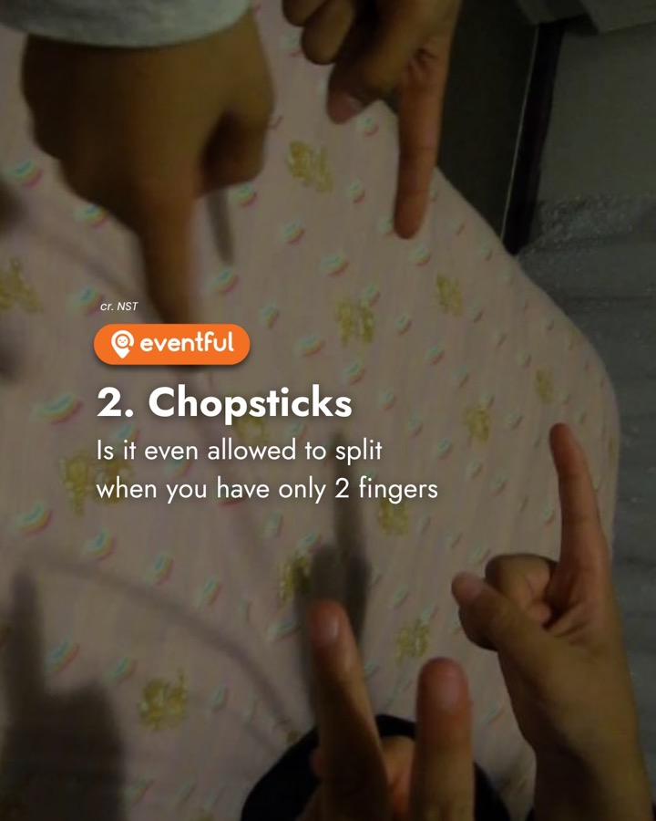 Two kids playing the chopsticks finger game