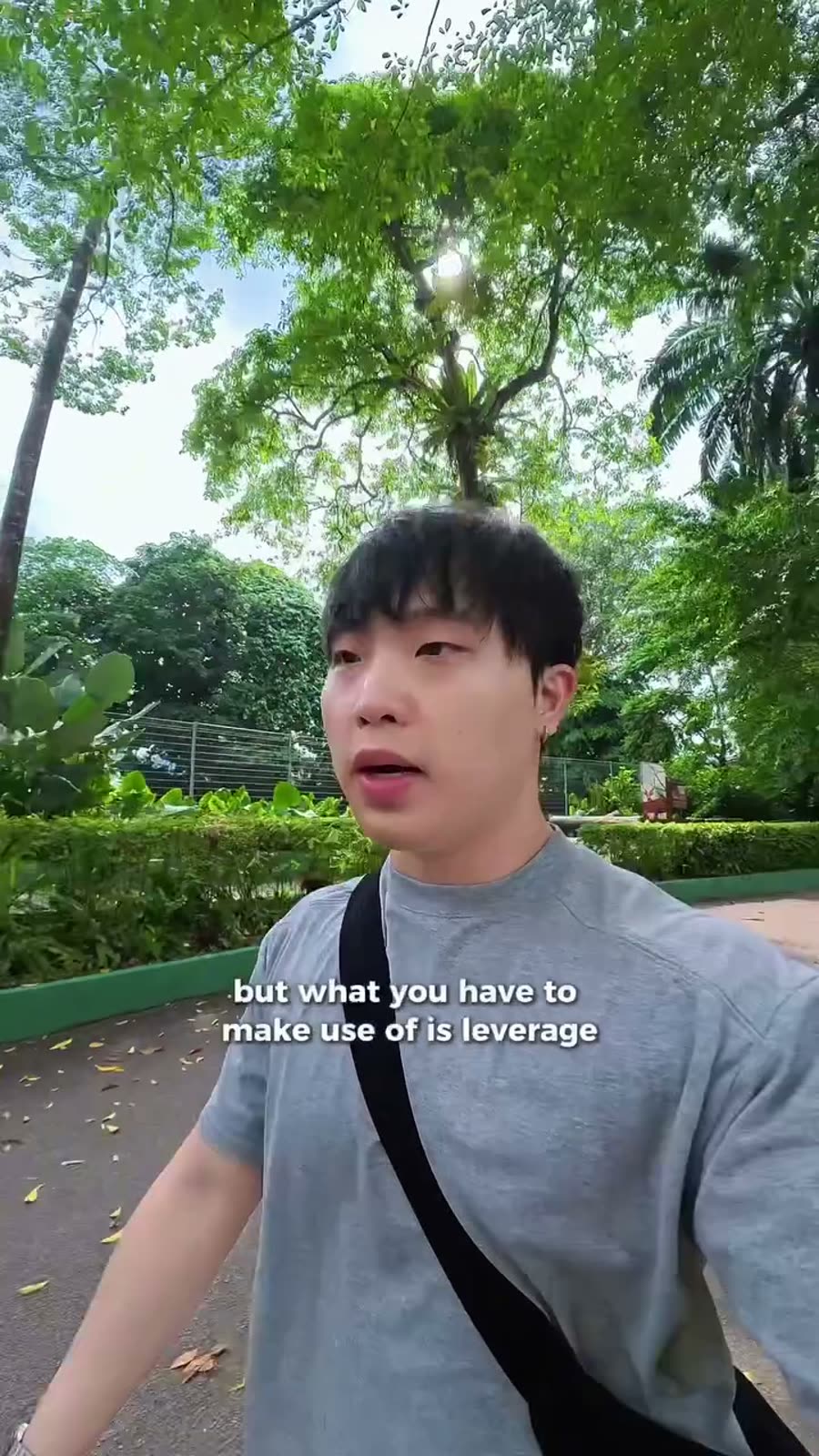Talking to camera while walking through a park in Singapore
