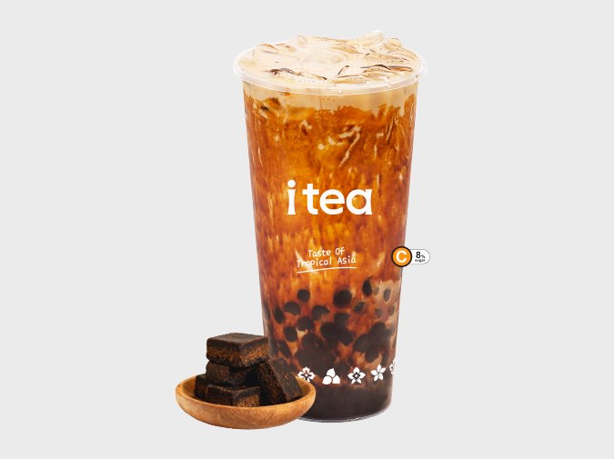 iTea Brown Sugar Pearl Milk Tea in a branded cup next to a bowl of brown sugar cubes