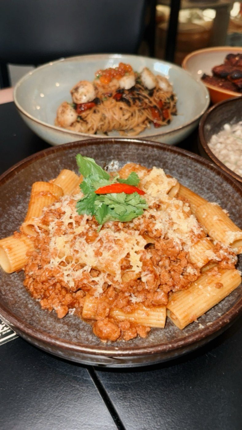 Rigatoni in a meat ragu topped with grated cheese and basil at Cheeselads