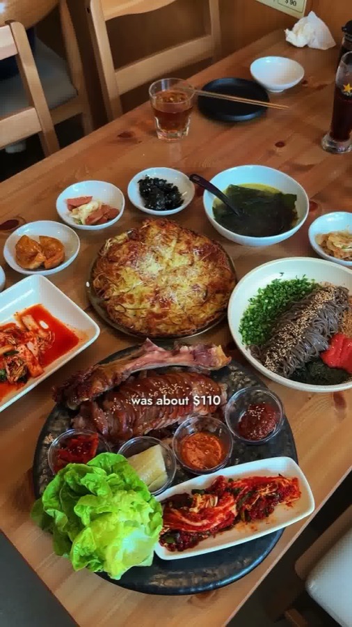 JANCHI table with pig trotters, cheese pancake, buckwheat noodles, seaweed soup and banchan