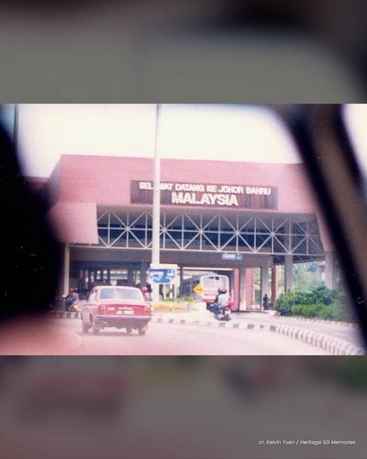 The old Johor Bahru checkpoint building with the Selamat Datang ke Johor Bahru sign, seen from a car