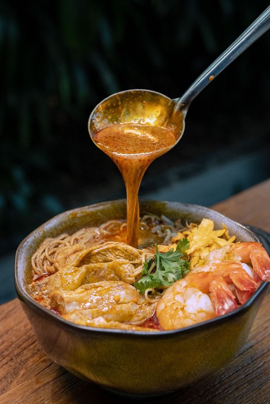 Sarawak laksa at KANTIN, sambal broth poured over prawns and noodles