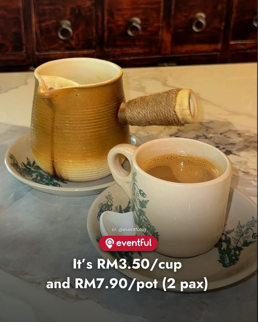 A clay coffee pot with a rope-wrapped handle beside a cup of claypot coffee at Lingtang, Cheras