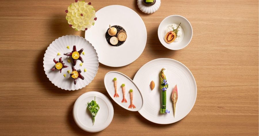 Several plated courses from the tasting menu at Loca Niru