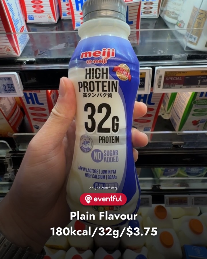 A bottle of Meiji High Protein milk, Original flavour, with 32g protein, held up in the FairPrice chiller