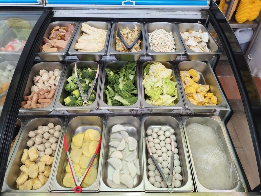 Vegetables, fishballs, tofu and potatoes on the Family Mookata counter