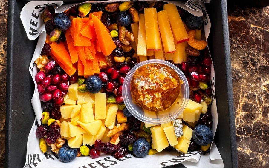 Inside the PRESSED! mystery cheese box: four cheeses, honeycomb, dried fruit, nuts and berries around the condiment cup