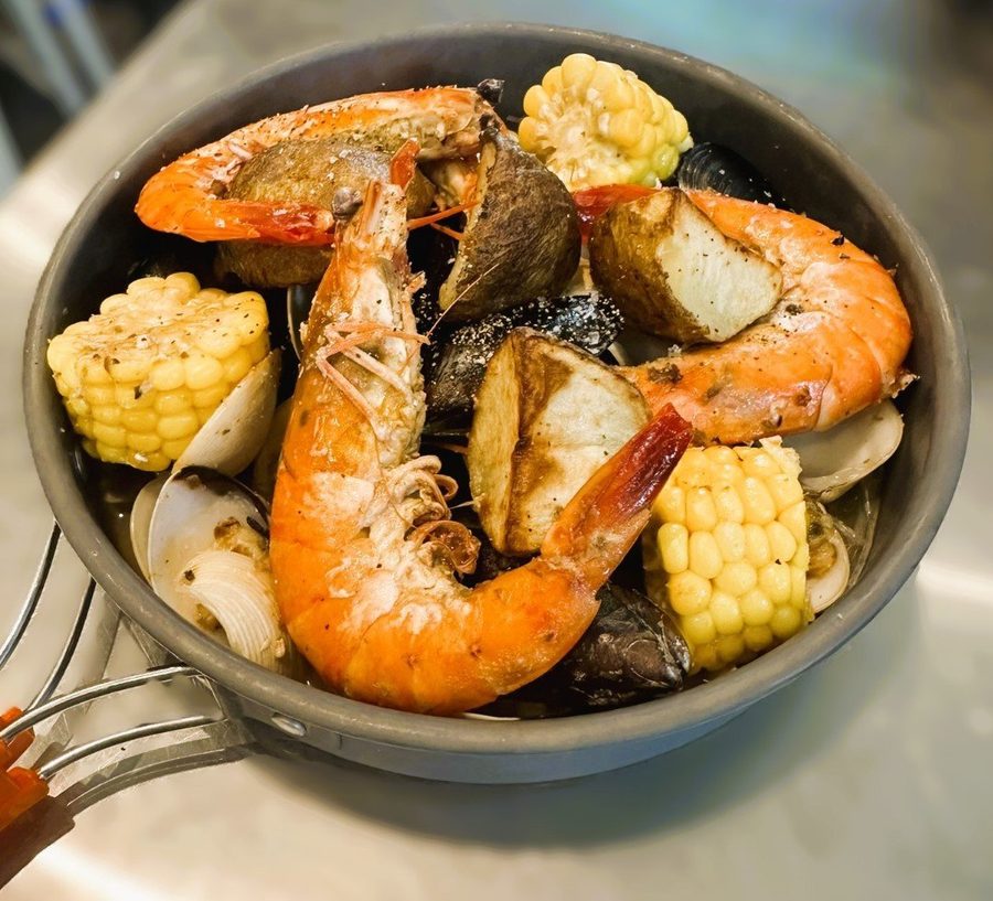 Shrimp Boil Foil with prawns, corn and potato in a pan at NOMADS