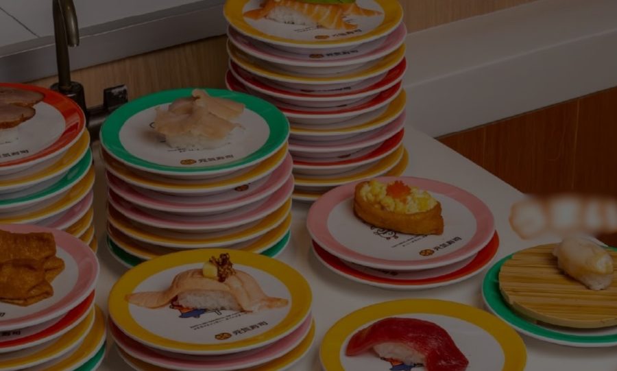A Ya Kun pie on a red plate with kopi in the background