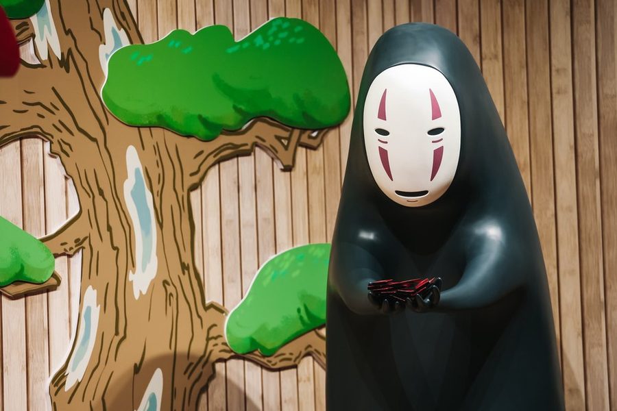 No Face figure seated under a Totoro tree at The Story of Studio Ghibli