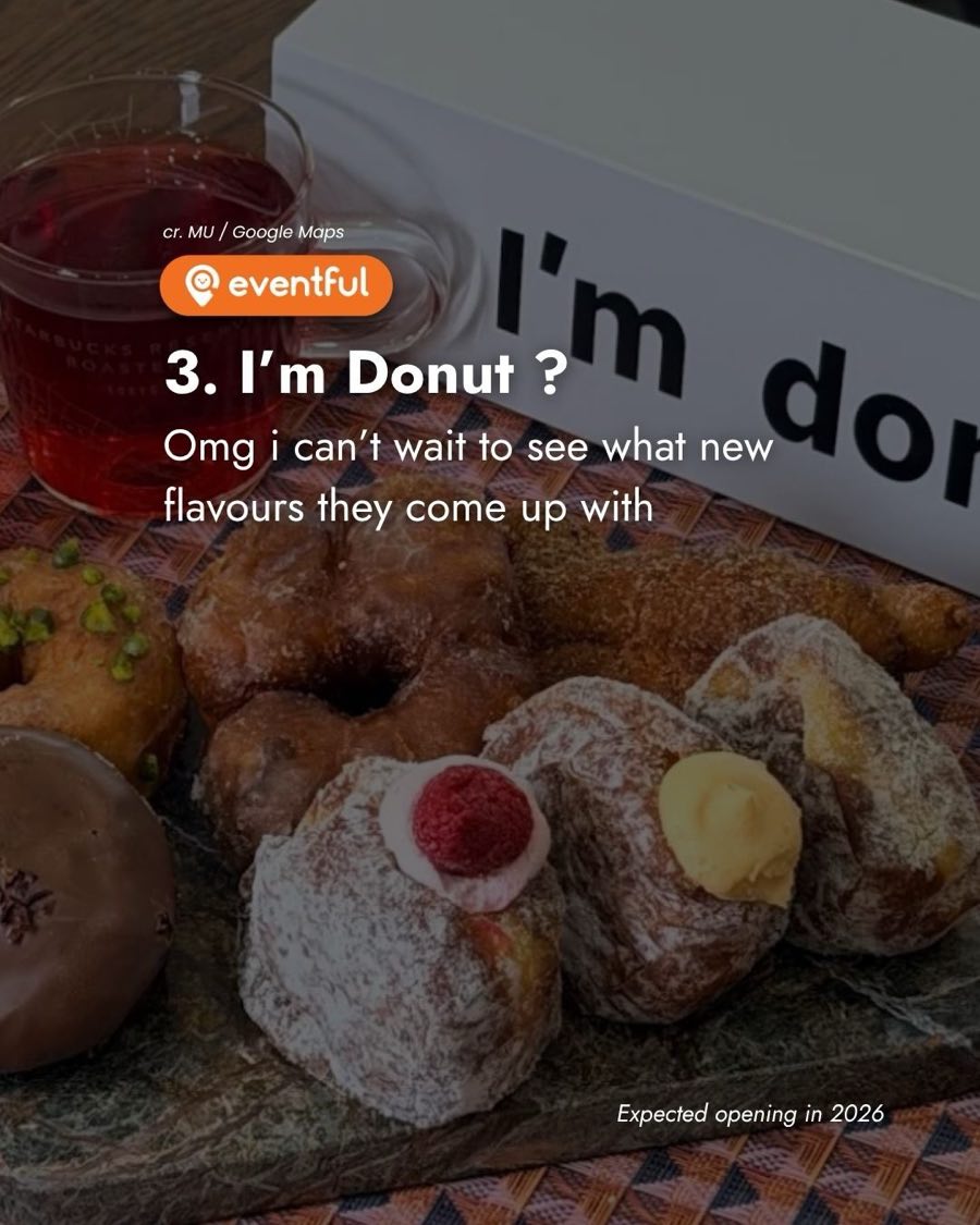 A box of I'm donut? doughnuts, including a raspberry cream one, a custard one, a chocolate glazed one and a pistachio one