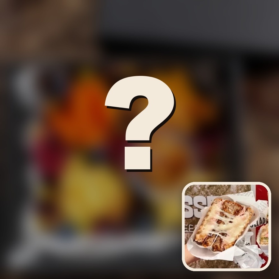 The mystery cover of Eventful Drop #001: a blurred cheese box behind a giant question mark, with the grilled cheese inset